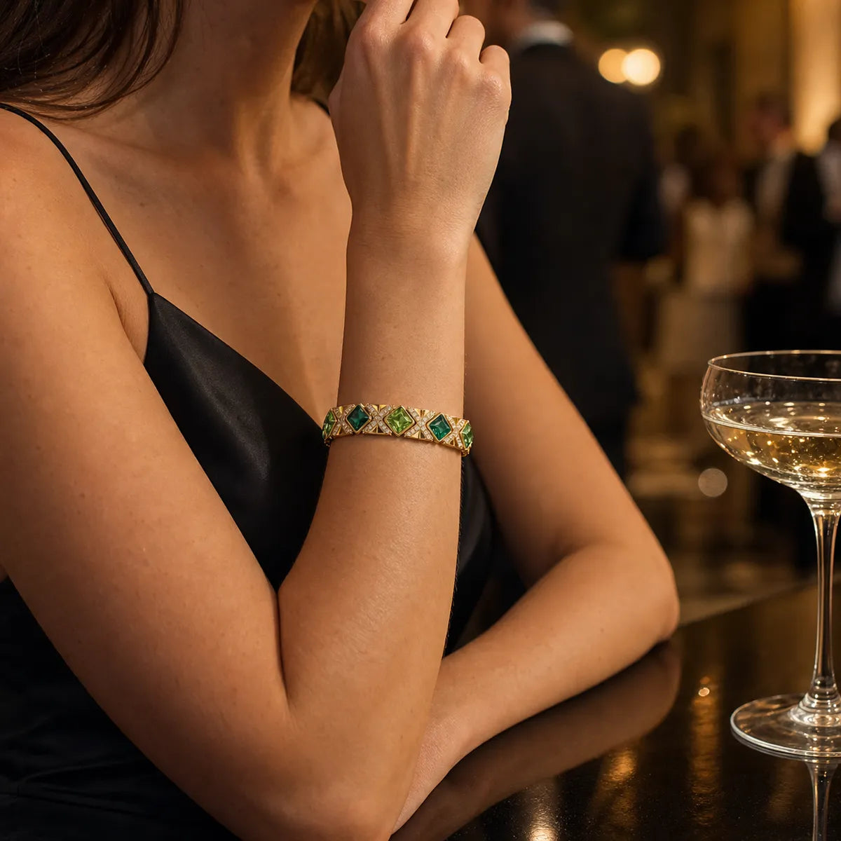 Woman wearing the Gilded Epoch green and gold statement bracelet at an evening reception