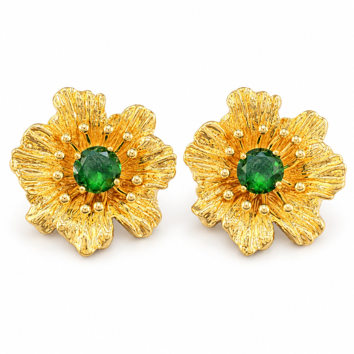 Pair of vintage gold-plated flower stud earrings with green rhinestone centers on white.