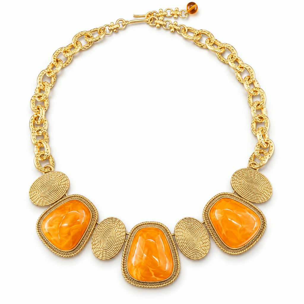 Vintage orange amber gold-plated statement necklace on a white background