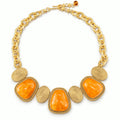 Vintage orange amber gold-plated statement necklace on a white background