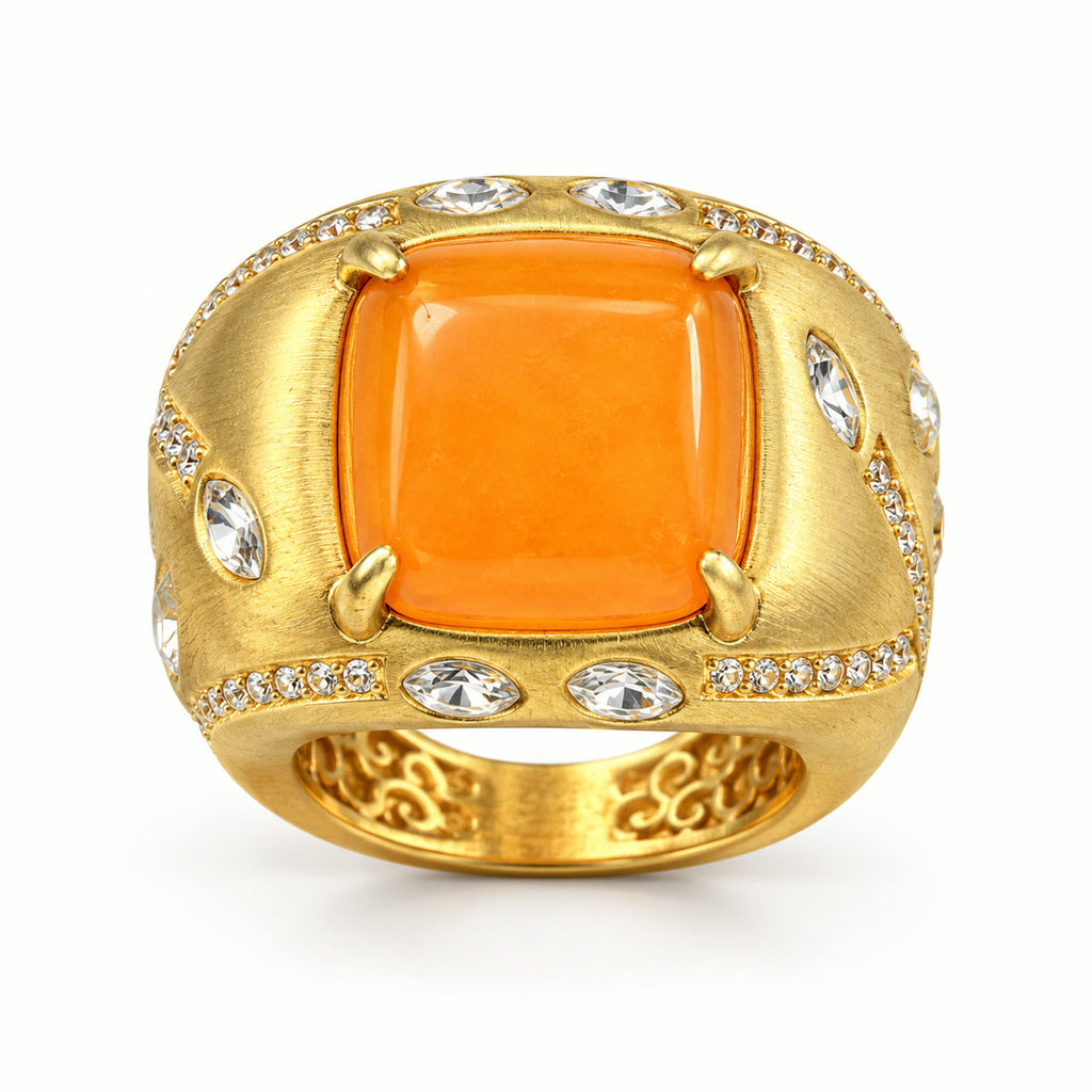 Vintage orange amber gold-plated cocktail ring on a white background