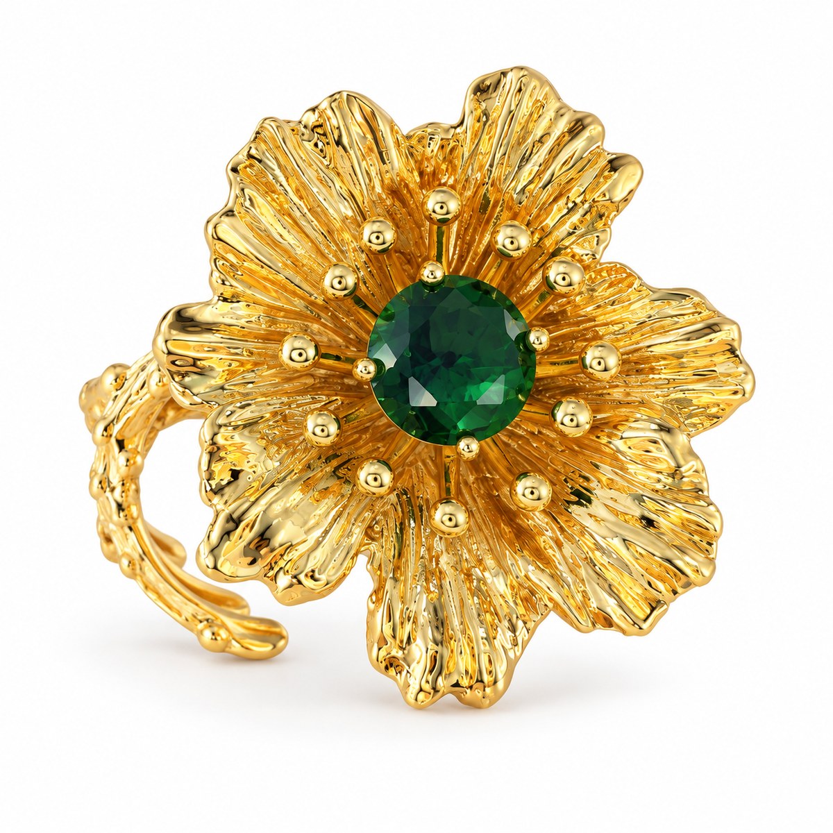 Vintage gold-plated flower ring with a green rhinestone center on a white background.