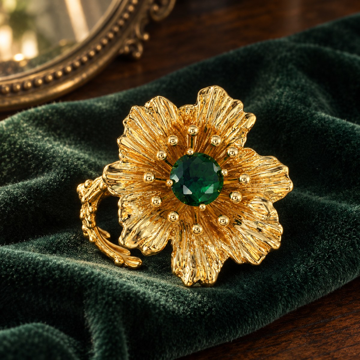 Gold-plated green rhinestone flower ring on dark green velvet with a vintage vanity background