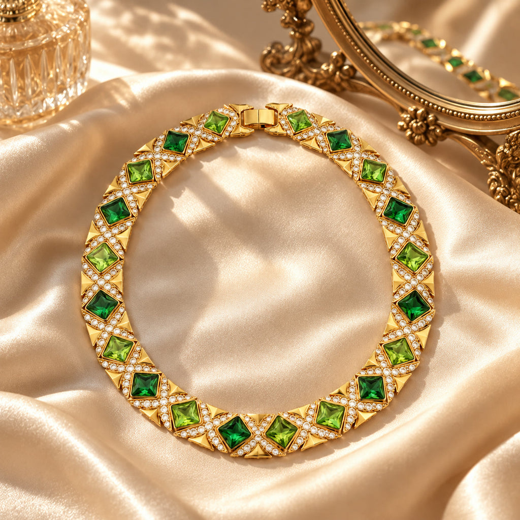 Vintage gold-plated green rhinestone necklace displayed on emerald velvet