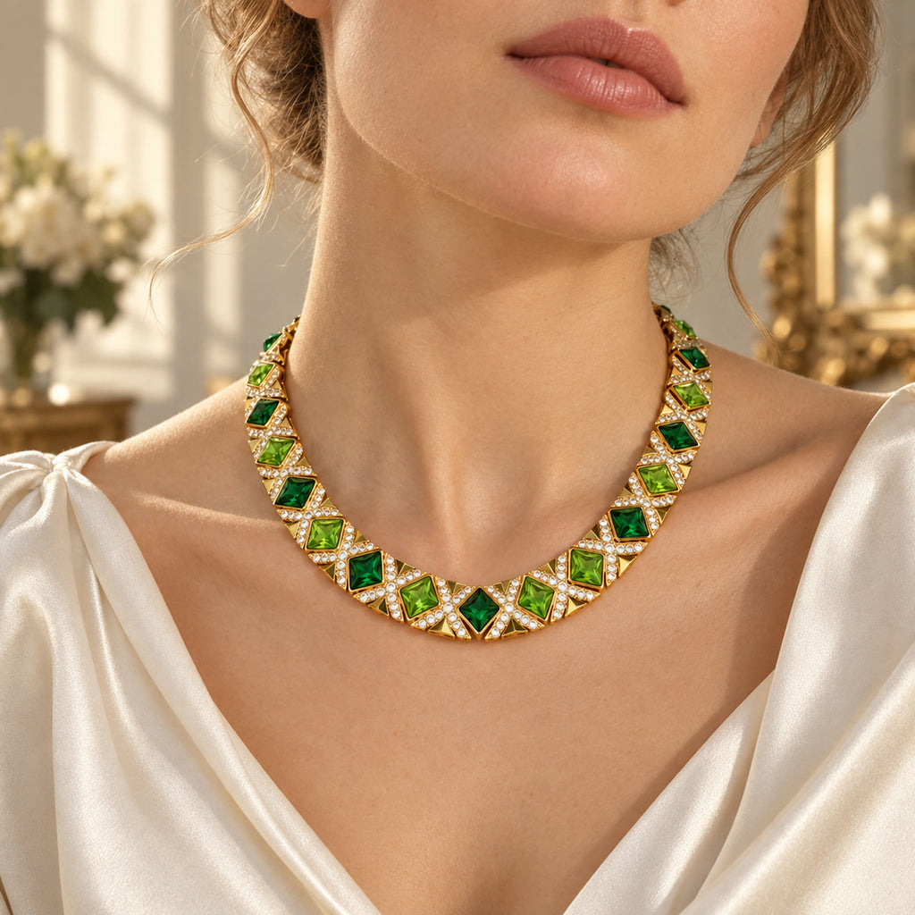 European woman wearing a vintage gold-plated green rhinestone necklace with a cream blouse