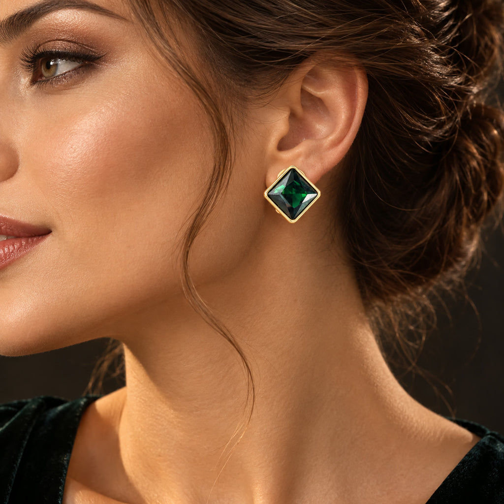 Close-up side view of 17mm gold-plated earrings with green rhinestones